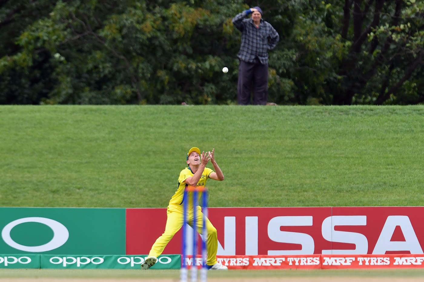 A spectator looks on as Ryan Hadley prepares to complete a catch