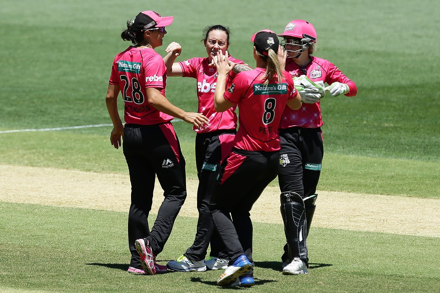 Sarah Coyte celebrates a wicket with team-mates