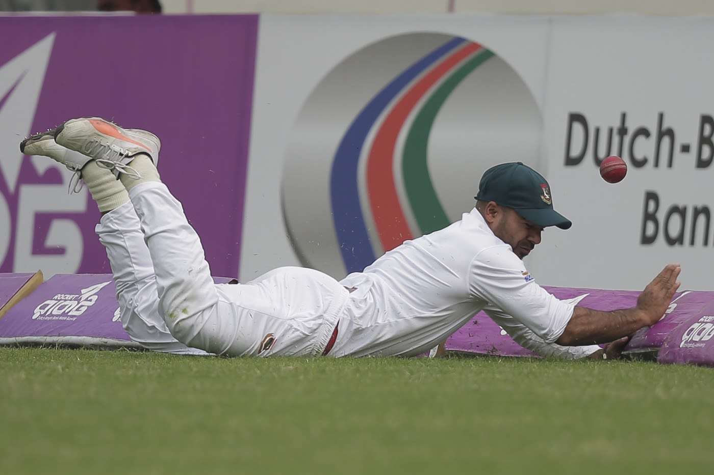 Substitute fielder Tanbir Hayder fails to stop a boundary