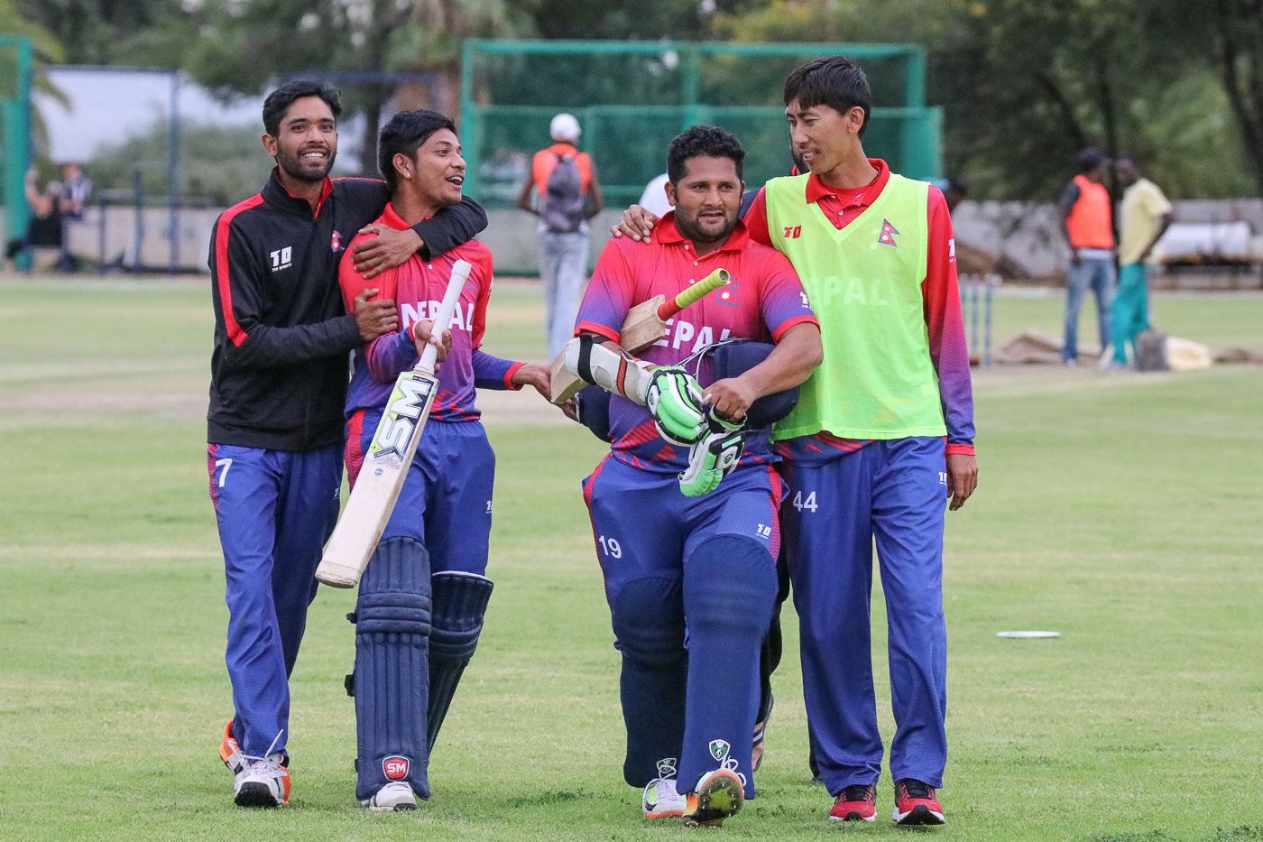 Sandeep Lamichhane and Basant Regmi are embraced by team-mates after their last-wicket stand clinched a one-wicket win
