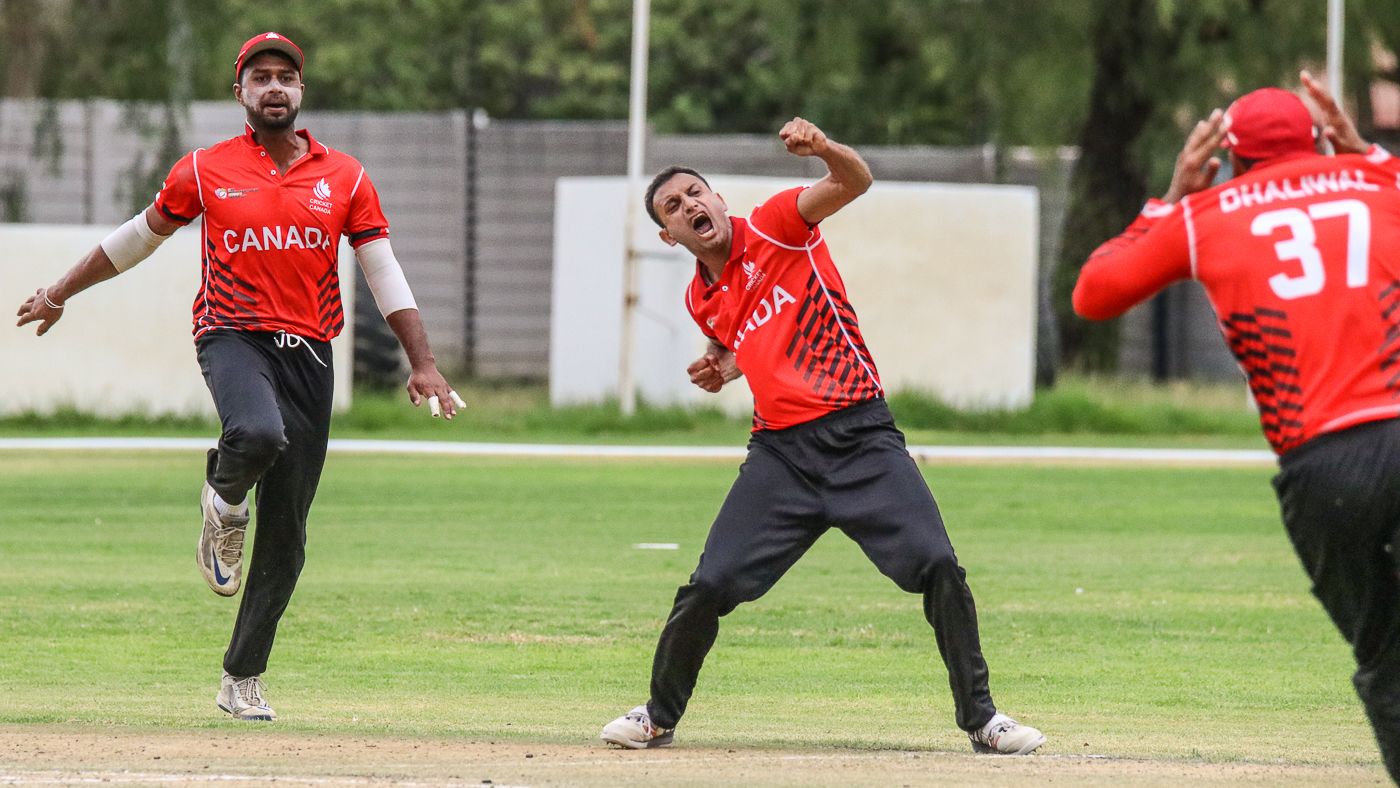 Cecil Pervez punches the air after claiming the final wicket to seal victory