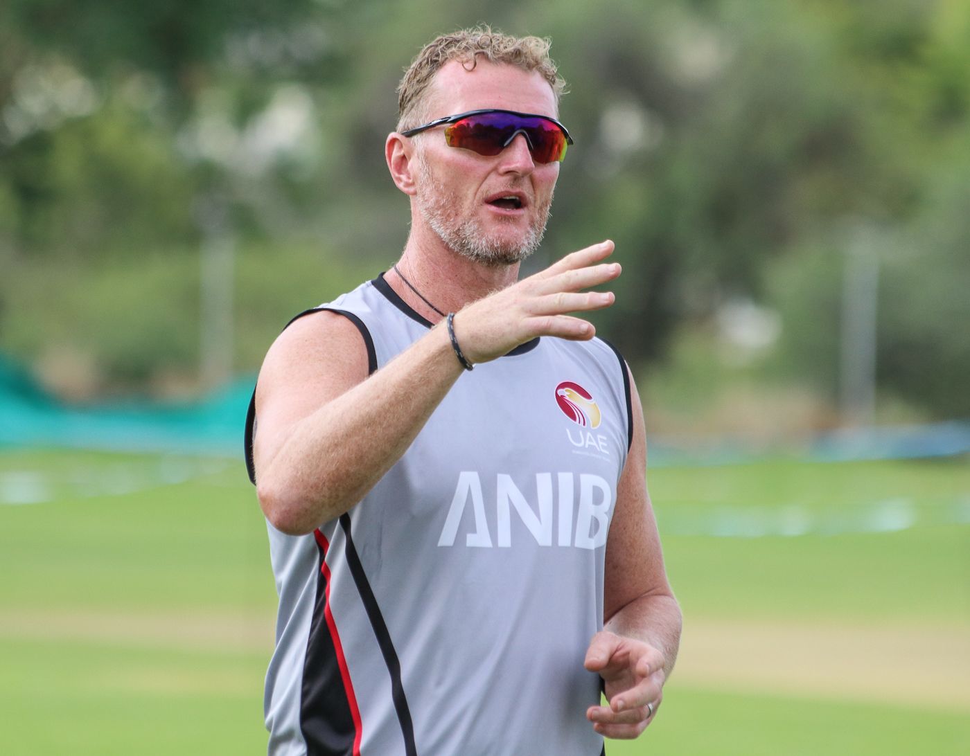 Coach Dougie Brown gives instructions to his squad ahead of a warm-up drill