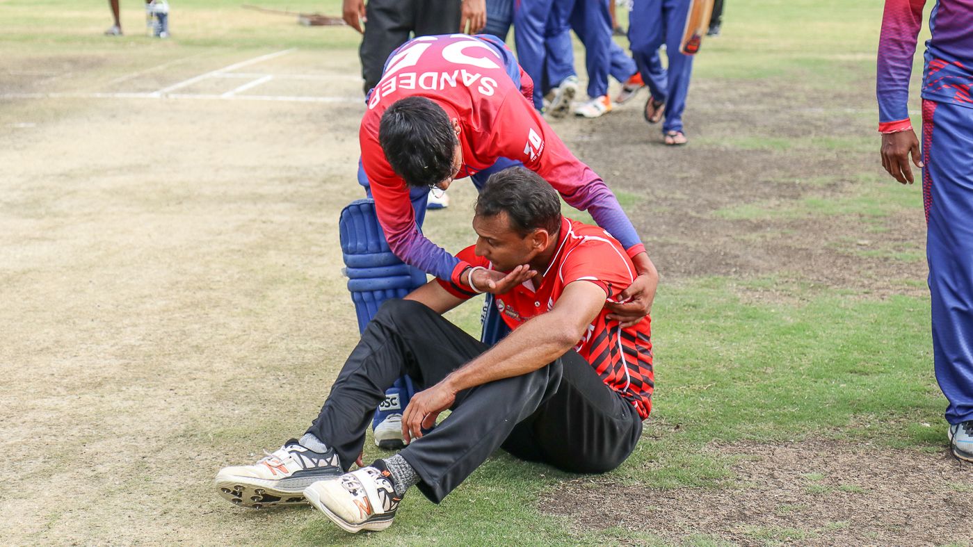 Sandeep Lamichhane consoles Canada medium pacer Cecil Pervez after the final ball