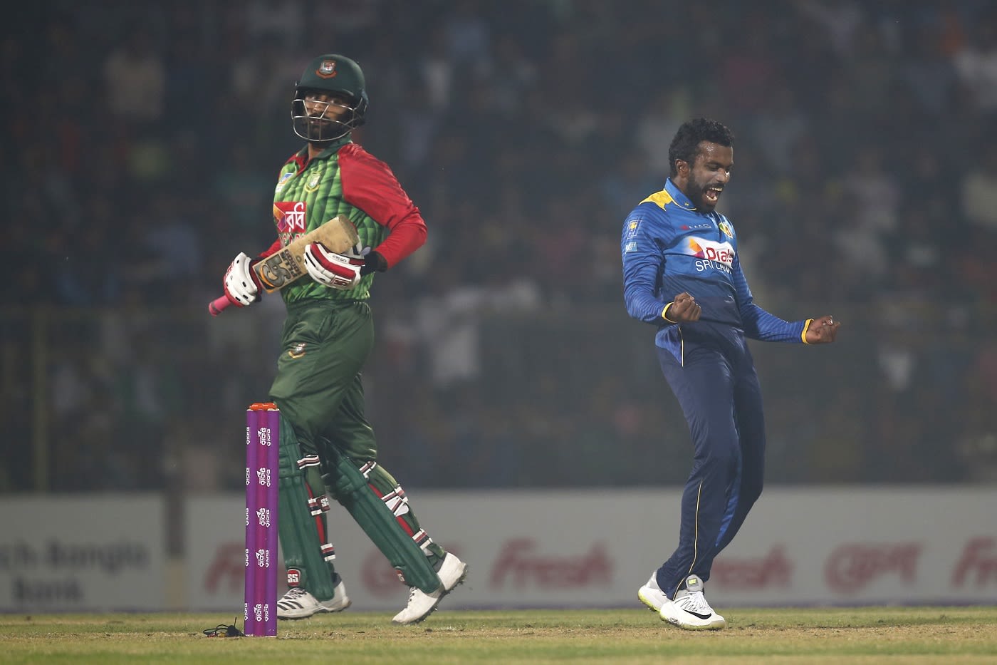 Amila Aponso celebrates the wicket of Tamim Iqbal