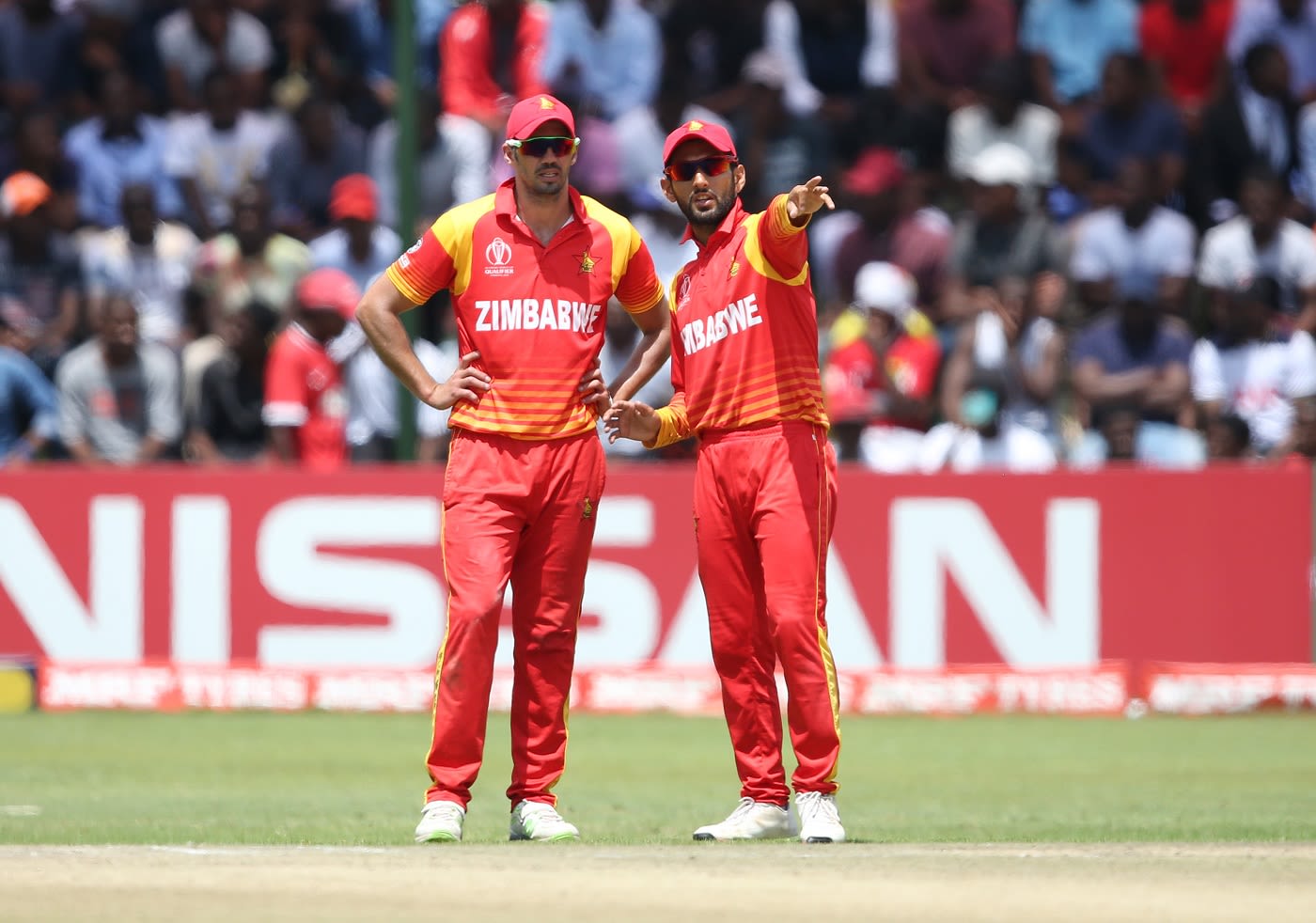 Graeme Cremer and Sikandar Raza discuss in the middle