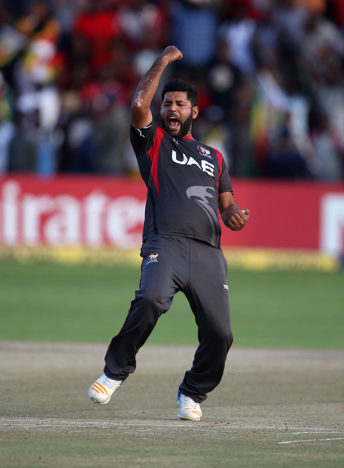 Mohammad Naveed exults after picking up a wicket