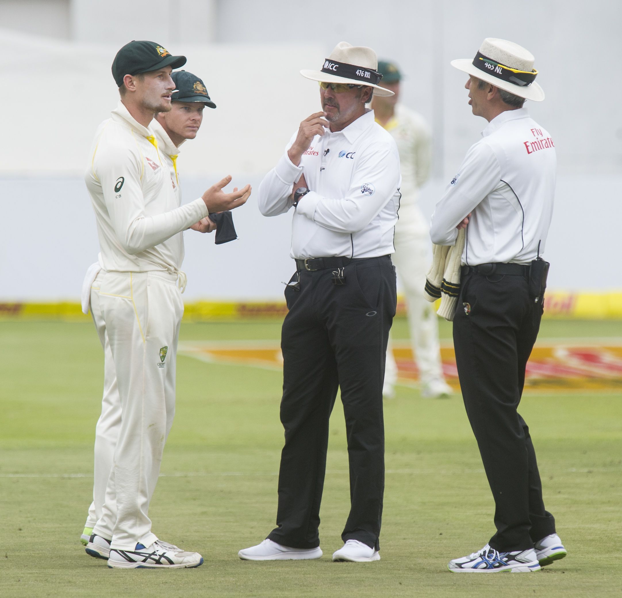 Cameron Bancroft shows a black piece of cloth to the umpires