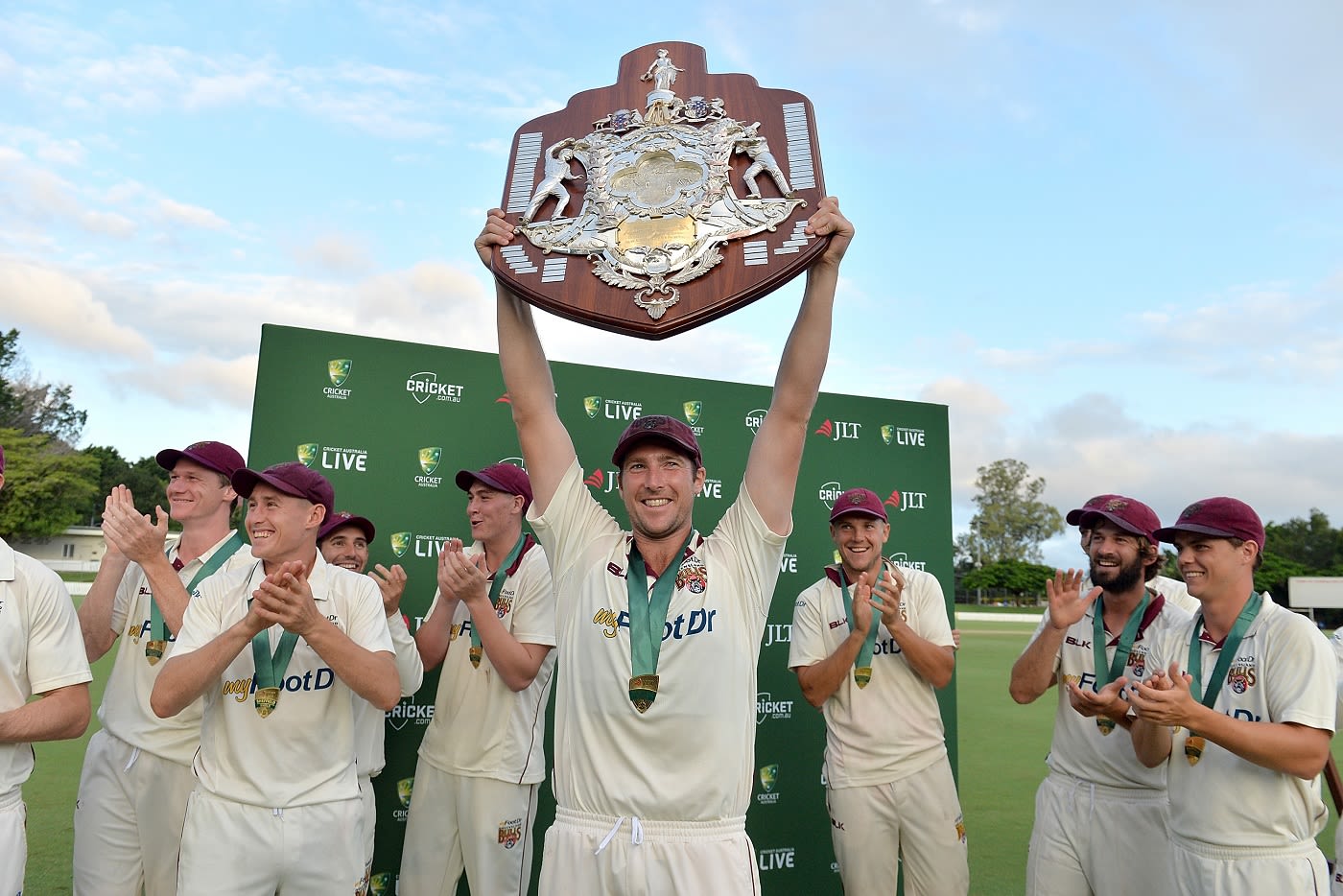 Luke Feldman holds the Sheffield Shield aloft
