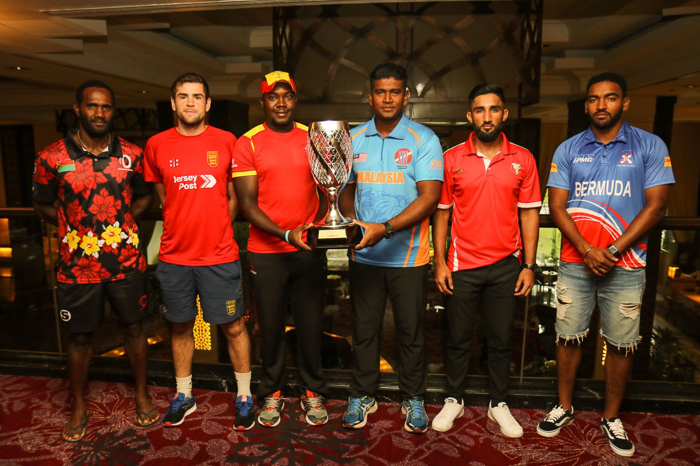 The six captains pose with the WCL Division Four tournament trophy, Kuala Lumpur