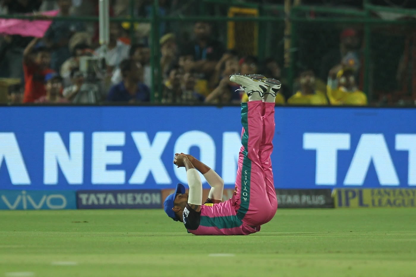 Stuart Binny falls on his back after taking a catch