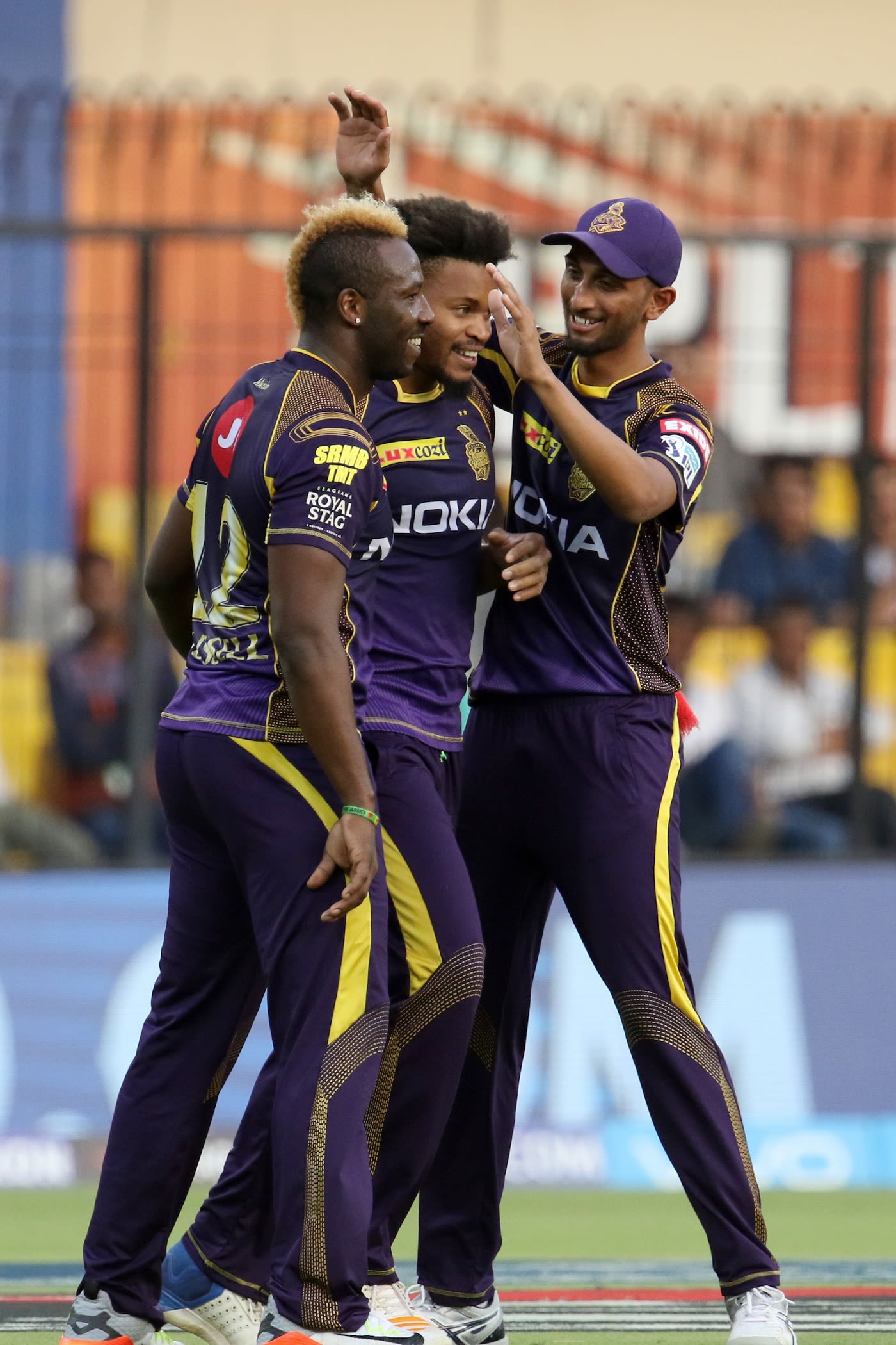 Andre Russell, Javon Searles and Prasidh Krishna celebrate a Kings XI wicket