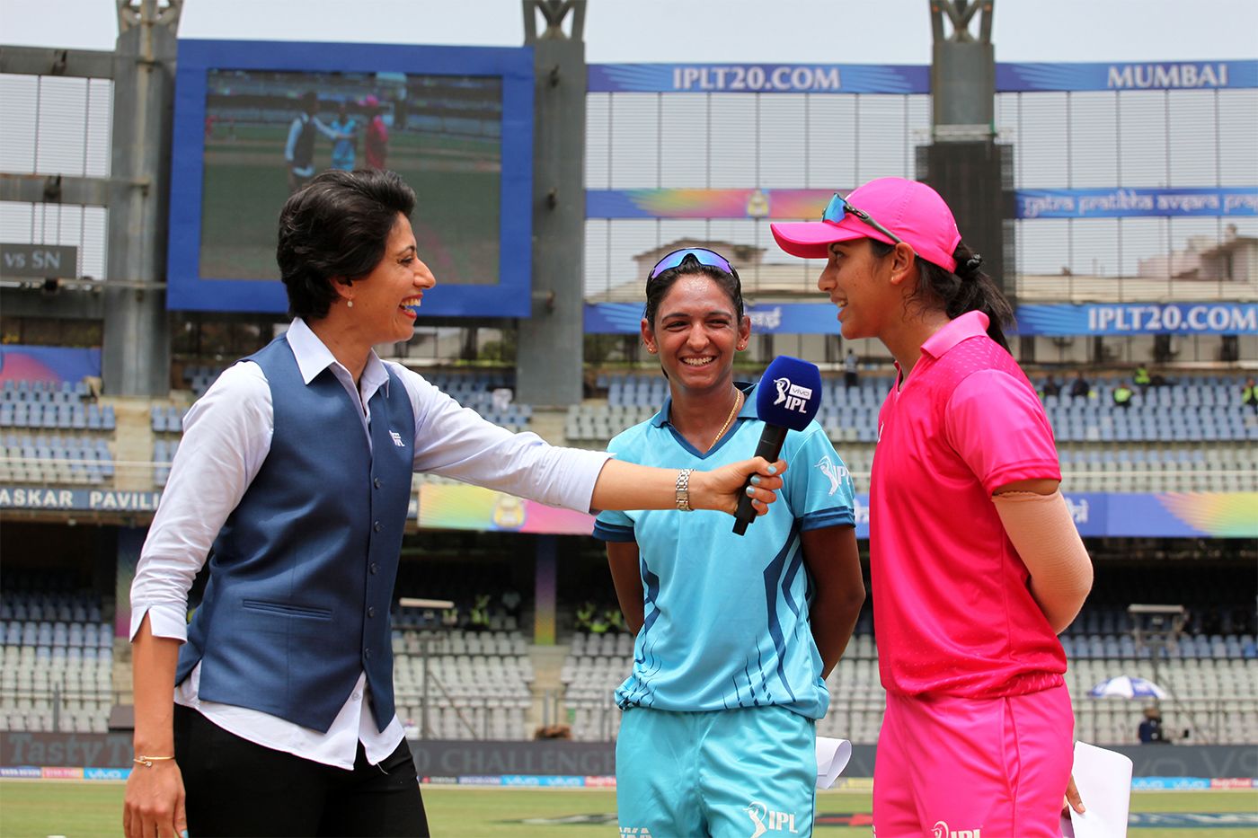 Supernovas' Harmanpreet Kaur and Trailblazers' Smriti Mandhana at the toss of the Women's T20 Challenge with Anjum Chopra
