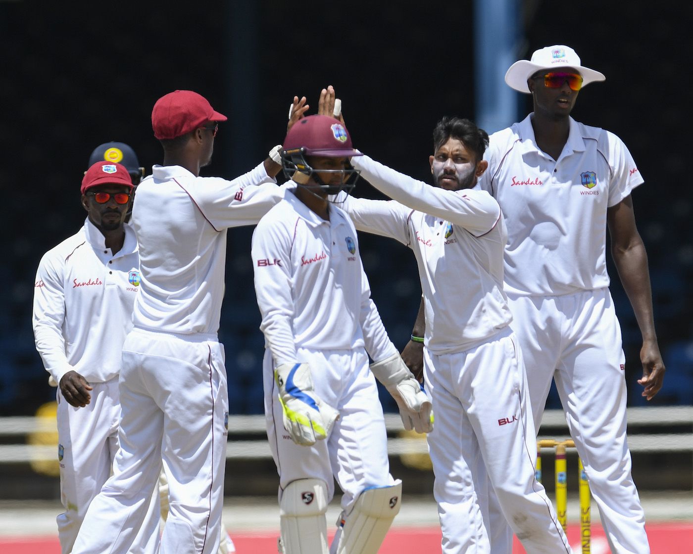 Devendra Bishoo is congratulated after taking a wicket