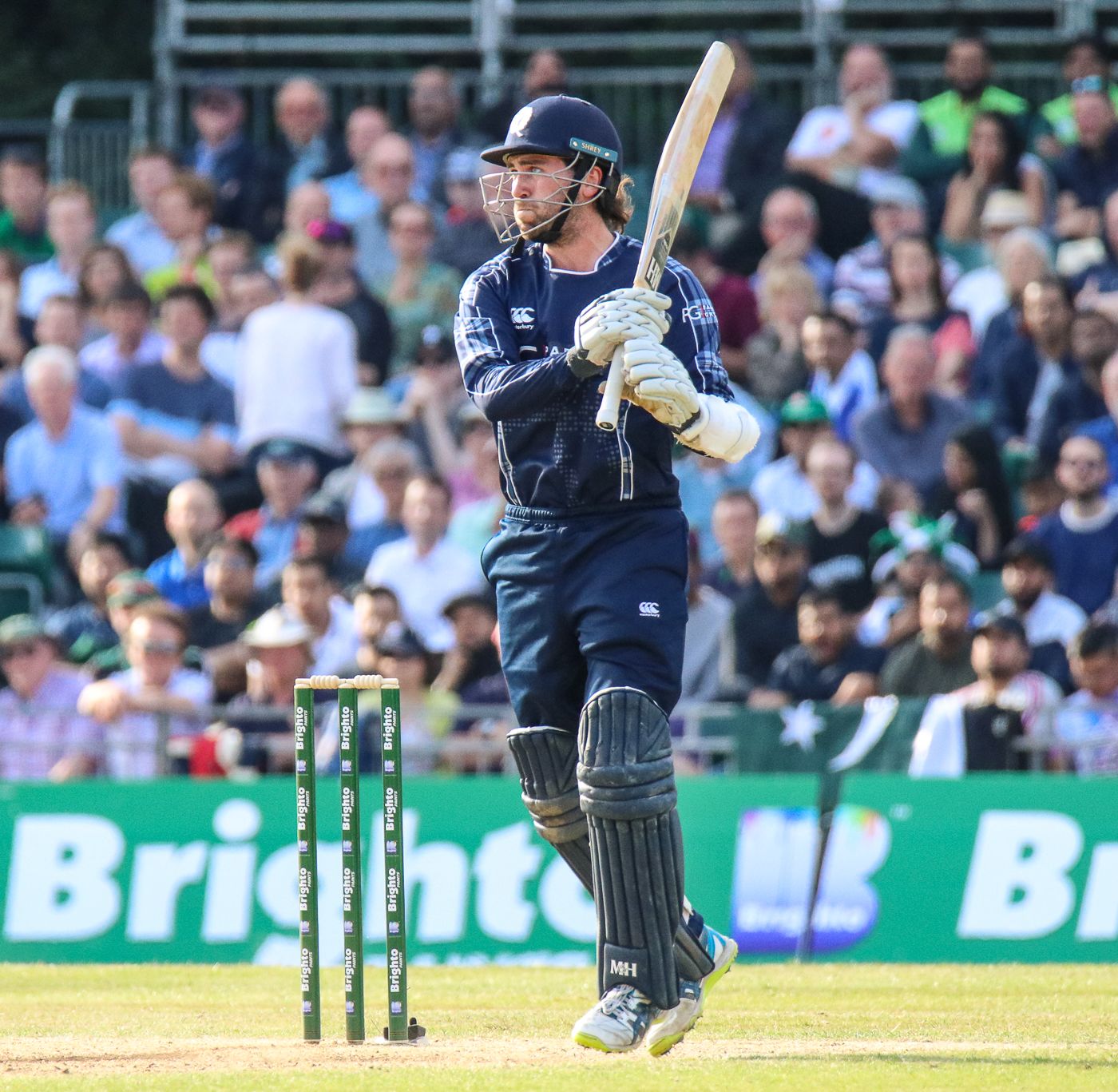 Dylan Budge watches the ball fly over the long-off boundary for six