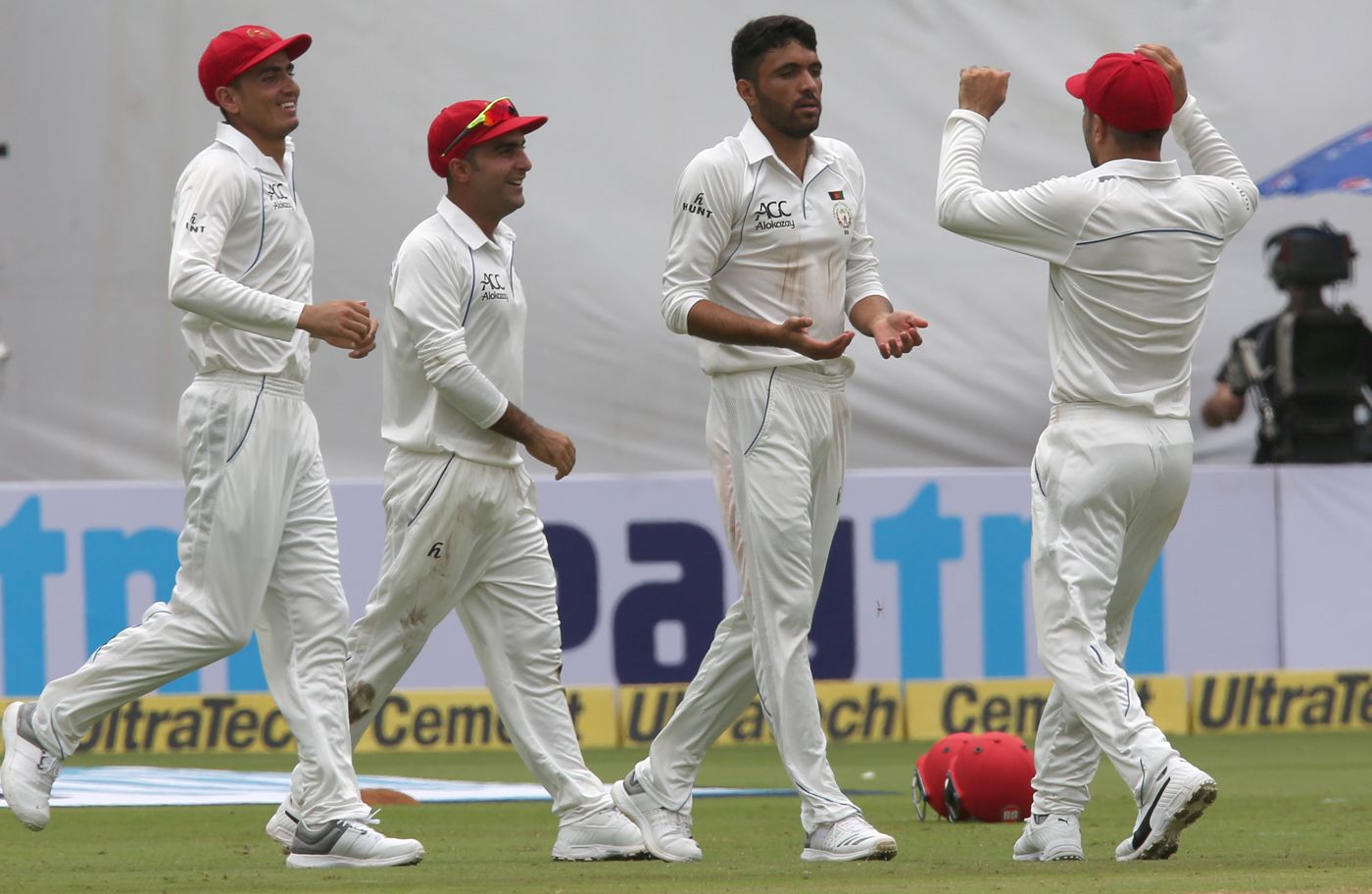 Yamin Ahmadzai is congratulated upon claiming Afghanistan's first wicket in Tests