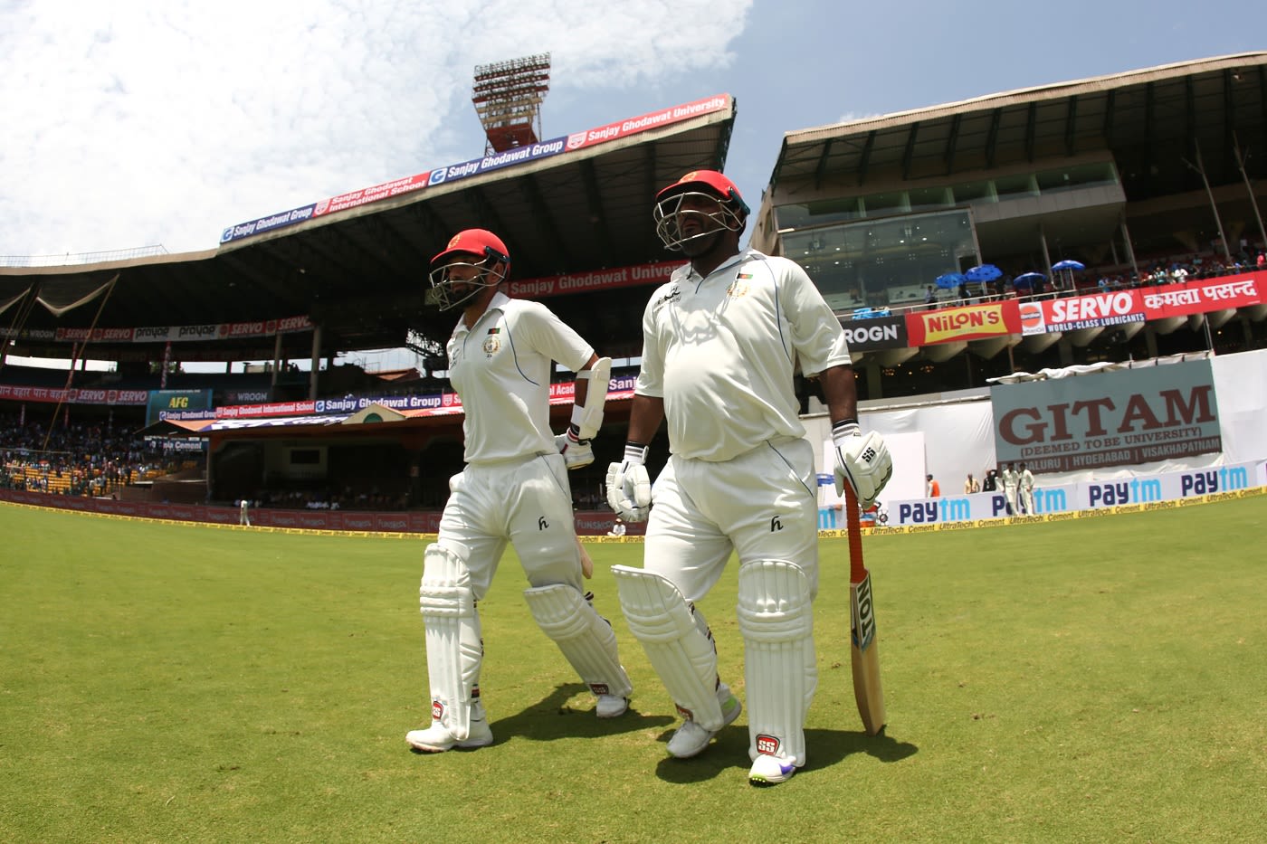 Mohammad Shahzad and Javed Ahmadi walk out to open the Afghanistan innings