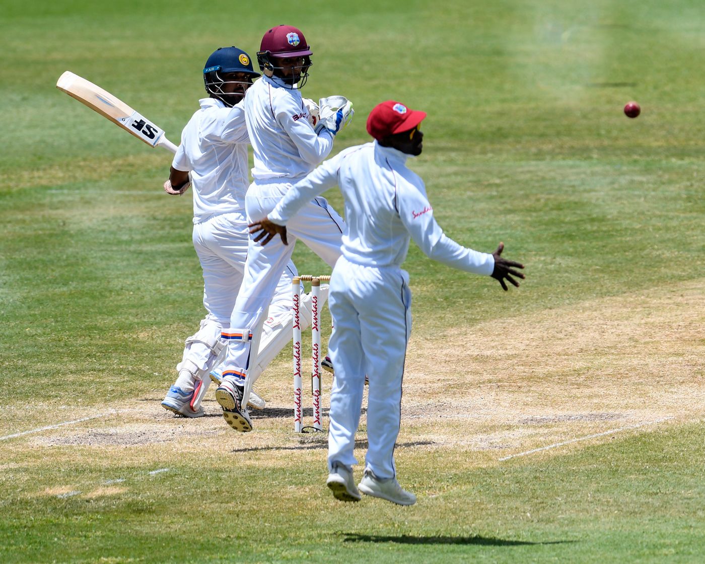 Dinesh Chandimal edges Devendra Bishoo wide of Devon Smith at slip