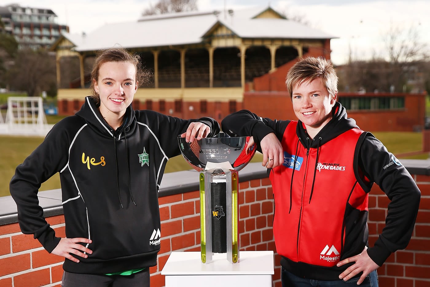 Makinley Blows and Jess Cameron pose with the WBBL trophy