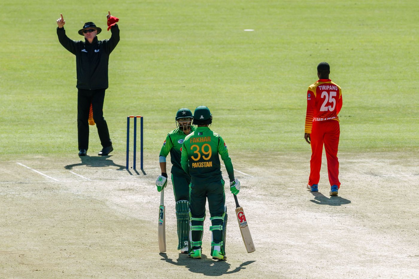 Russell Tiffin signals six after Fakhar Zaman hits Donald Tiripano over the top