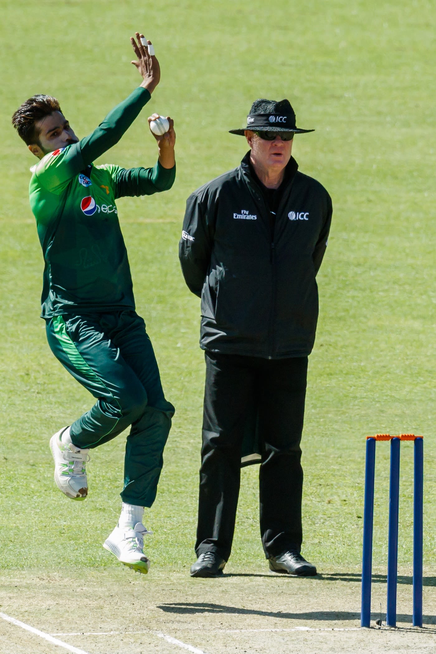 Mohammad Amir delivers a ball past Russel Tiffin
