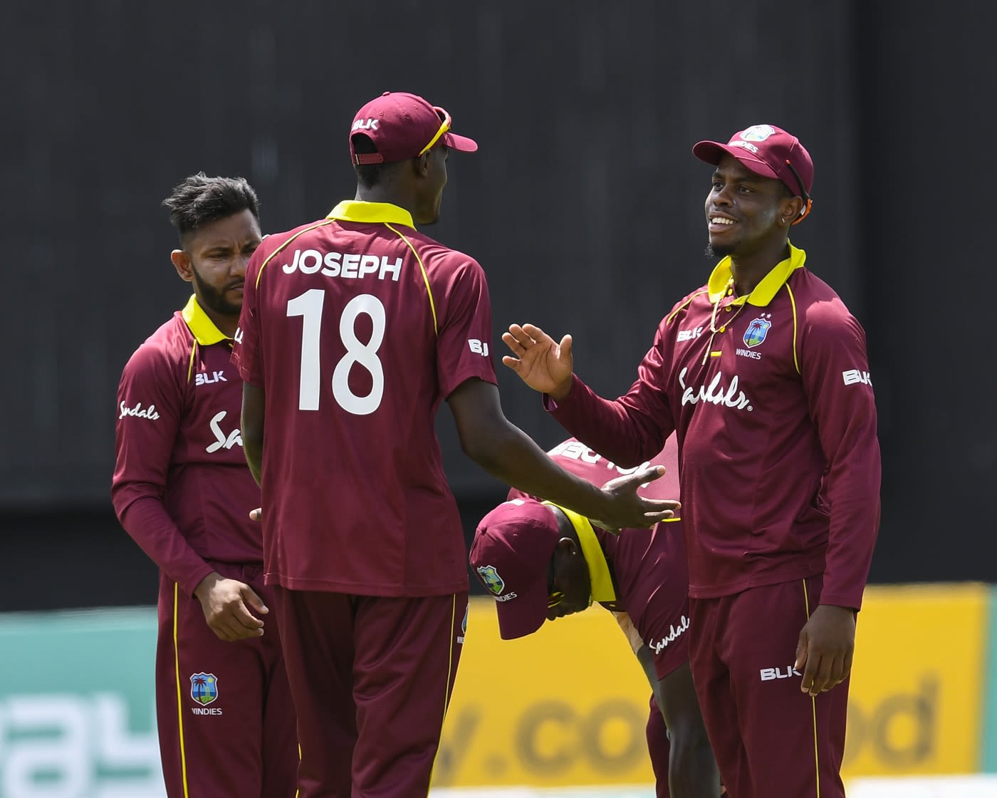 Devendra Bishoo, Alzarri Joseph and Shimron Hetmyer celebrate a wicket