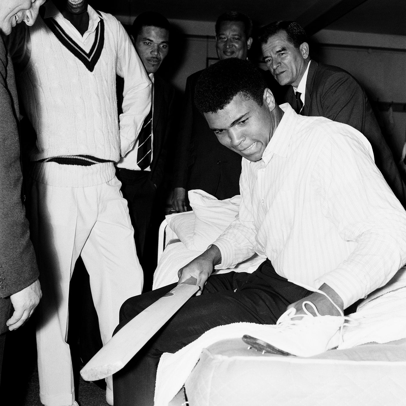 Muhammad Ali examines a cricket boot in the West Indies dressing room at Lord's