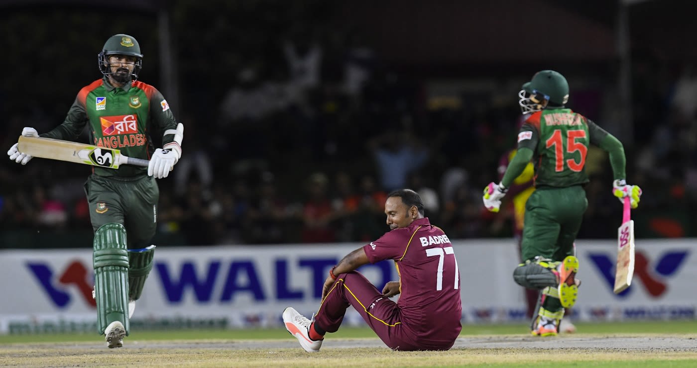 Samuel Badree is down on the ground as Liton Das and Mushfiqur Rahim take a run