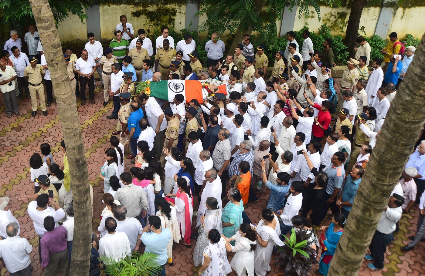 Relatives and friends carry the body of Ajit Wadekar to a crematorium in Mumbai