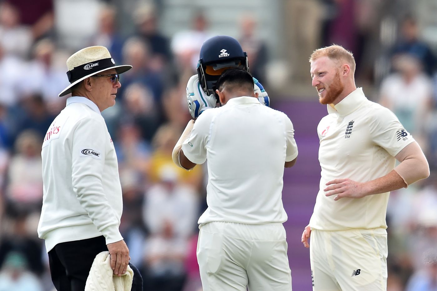 Ben Stokes checks on Cheteshwar Pujara after hitting him on the helmet with a short ball