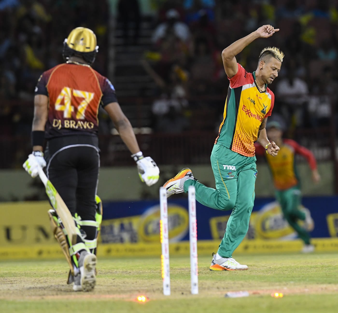 Rayad Emrit celebrates Dwayne Bravo's wicket