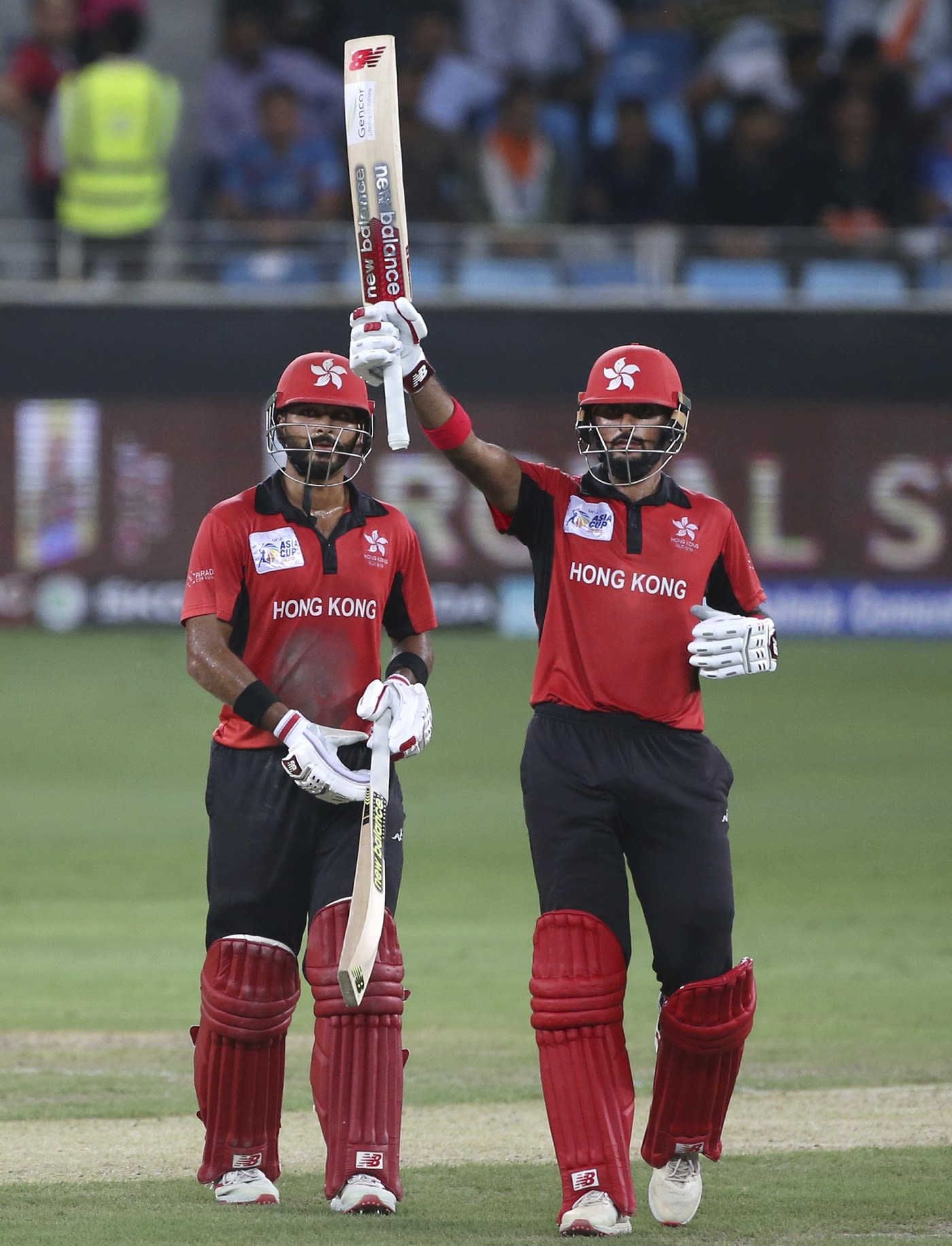 Anshy Rath looks on as Nizakat Khan raises the bat for his fifty