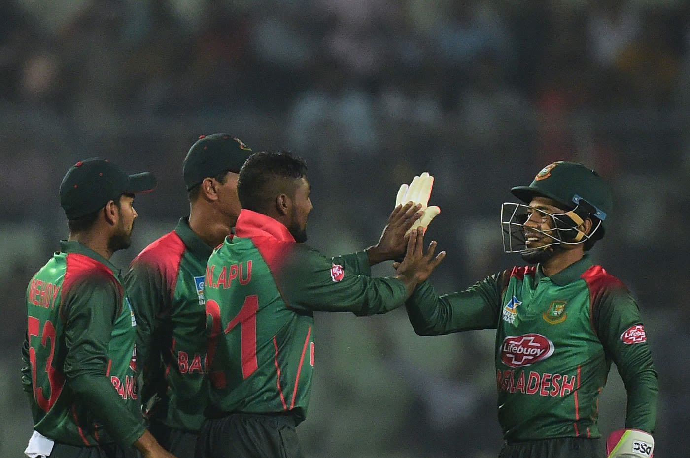 Nazmul Islam and Mushfiqur Rahim high-five each other