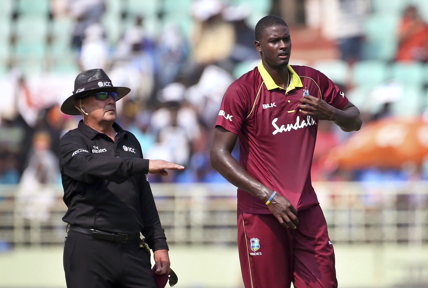 Jason Holder reacts after umpire Ian Gould signals four