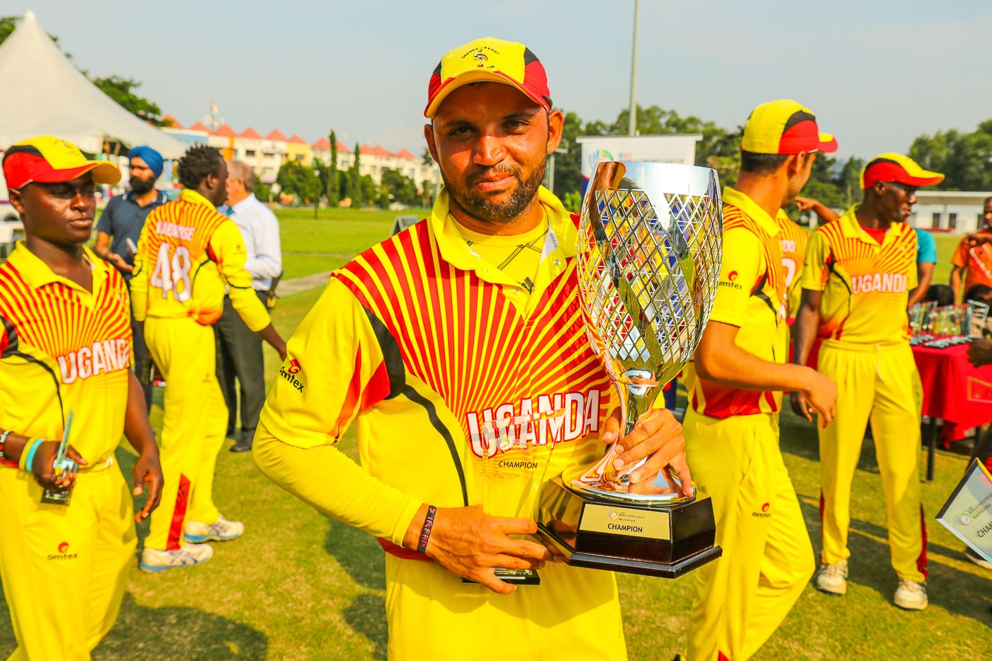 Irfan Afridi holds the spoils of victory after helping Uganda win WCL Division Four