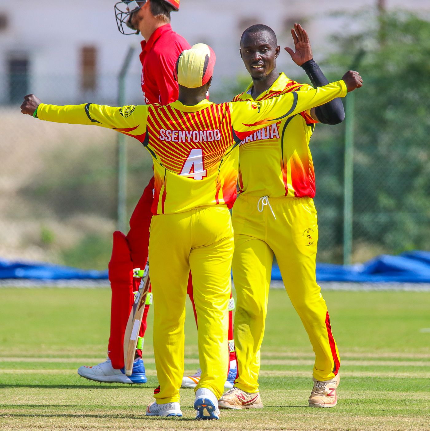 Charles Waiswa gets some love from Henry Ssenyondo after wiping out the tail with 4 for 25
