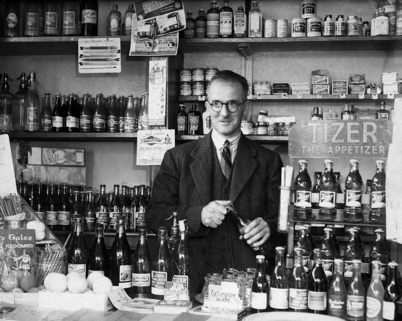 Harold Larwood behind the counter of his sweet shop