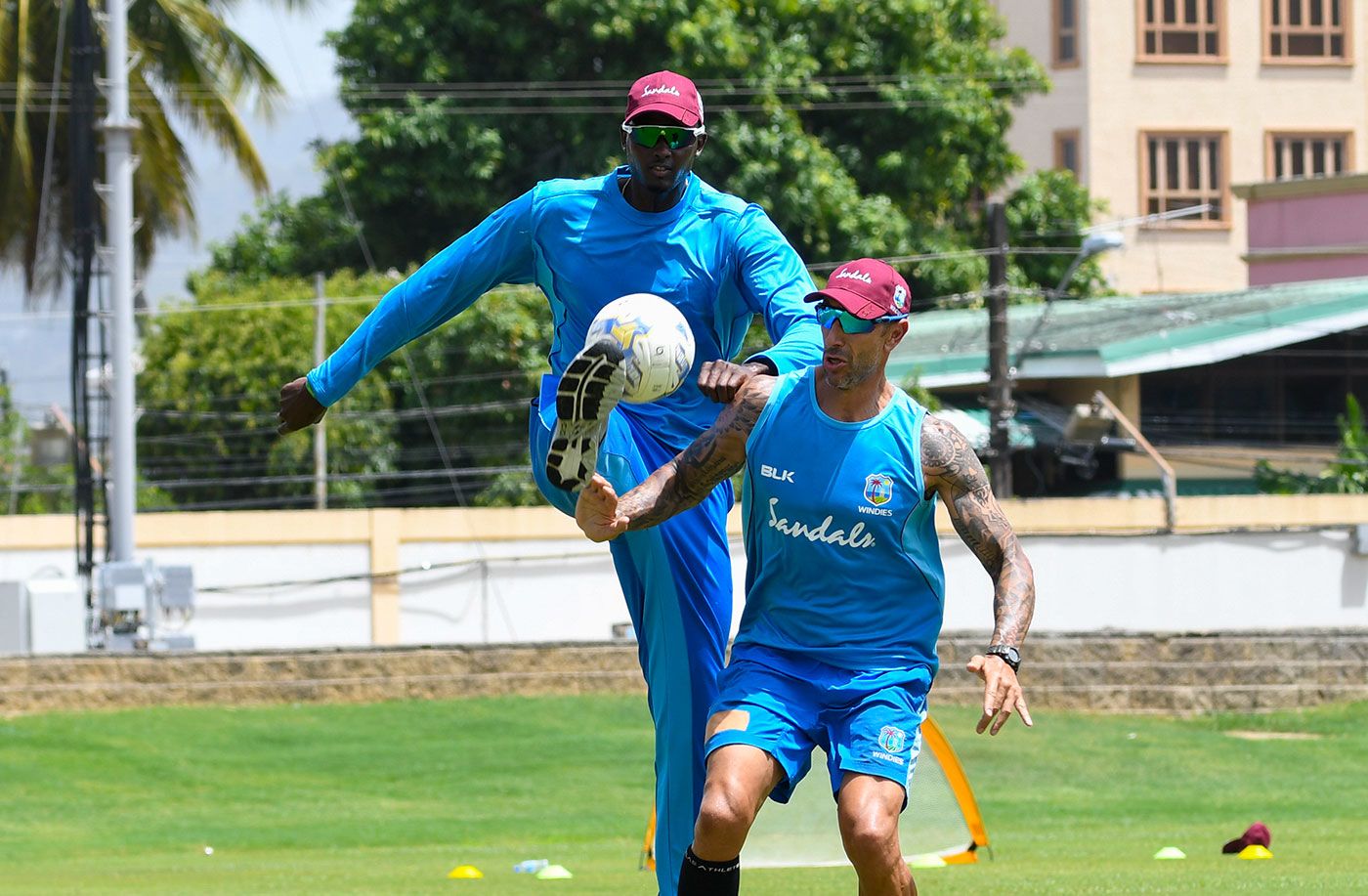 Nic Pothas plays football with Jason Holder