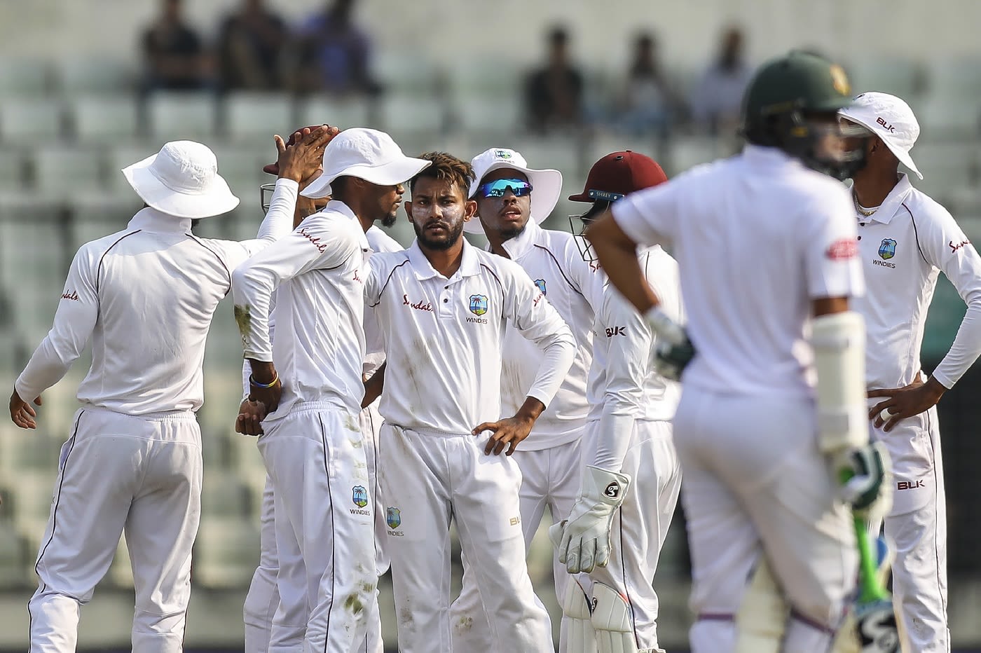 Devendra Bishoo celebrates a wicket with his team-mates