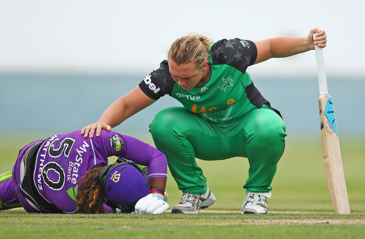 Hayley Matthews is consoled by Nicola Hancock after she suffered an injury