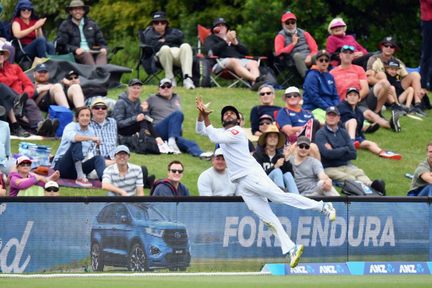 Roshen Silva with an acrobatic effort at the boundary