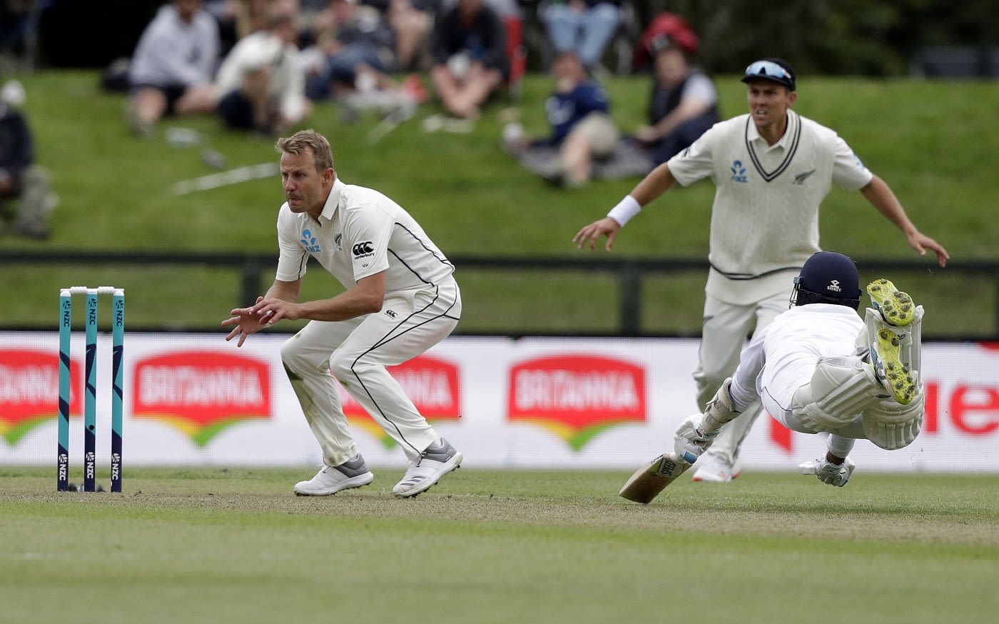 Roshen Silva dives to make his ground as Neil Wagner waits for the ball