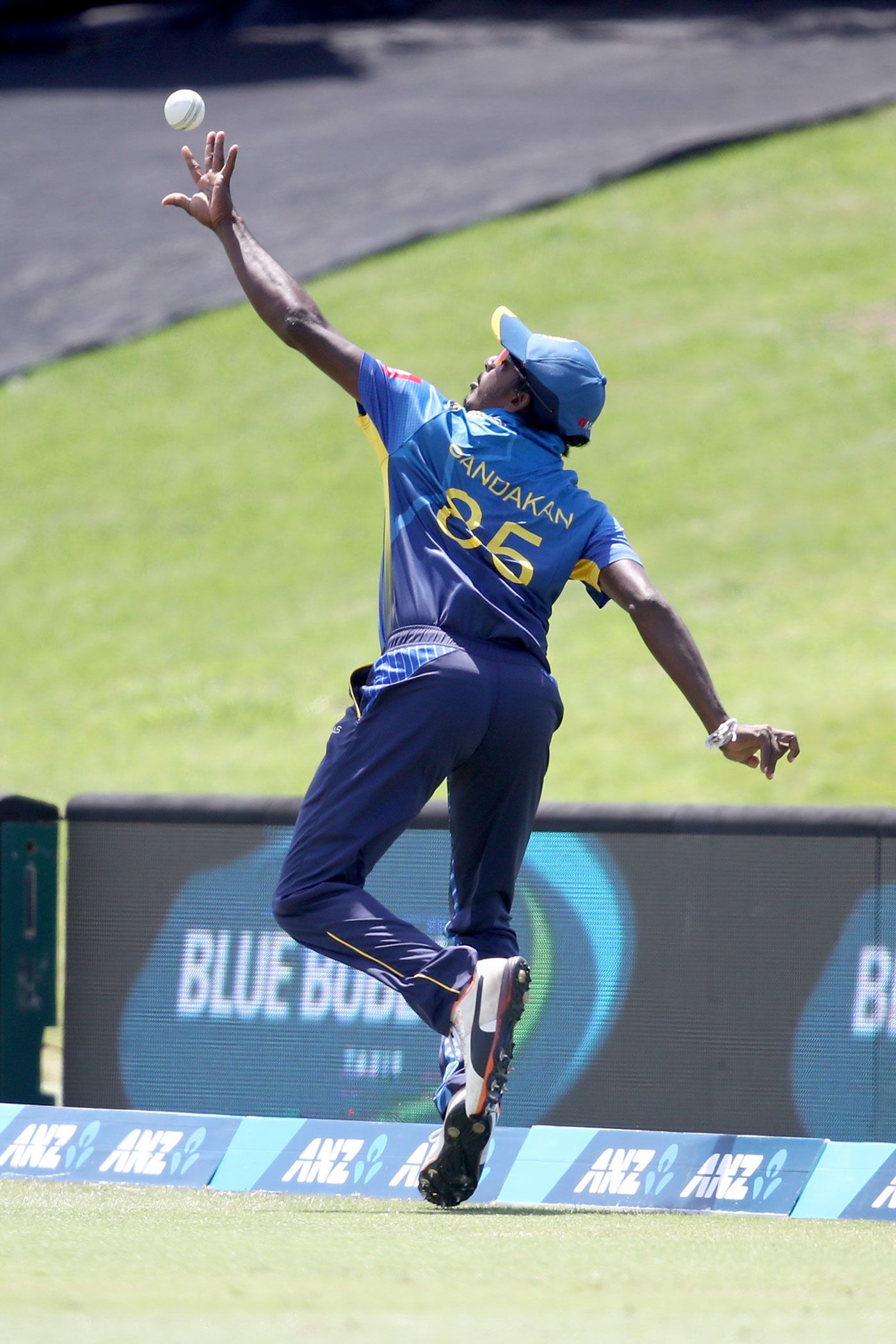 Lakshan Sandakan flicks the ball back into play before completing a catch