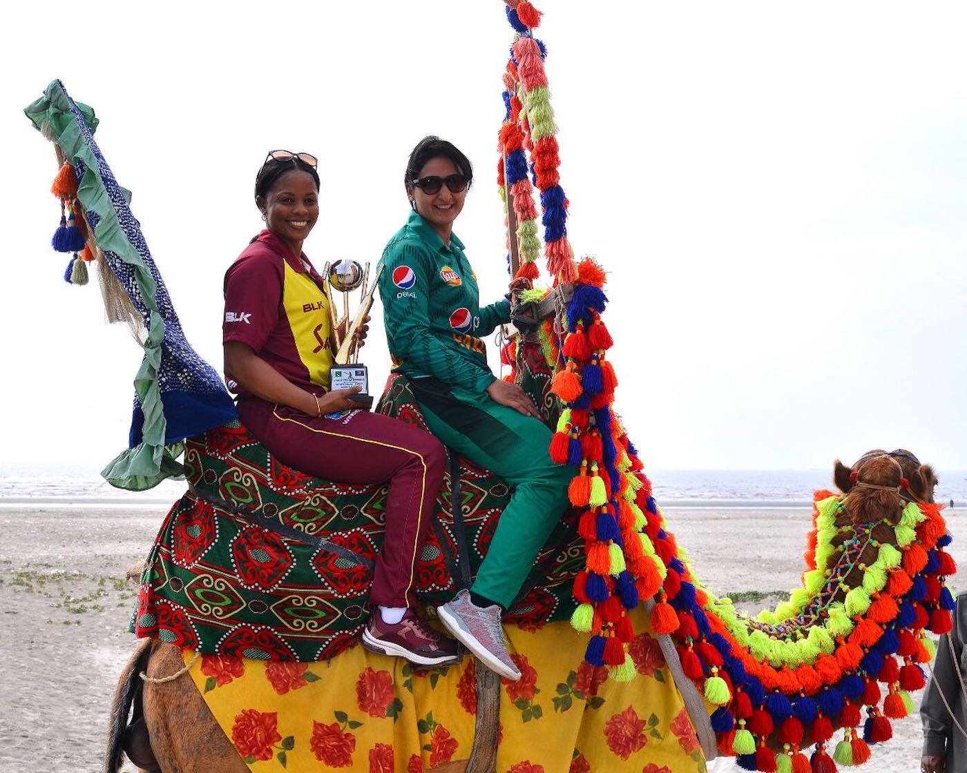 Merissa Aguilleira and Bismah Maroof pose with the T20I trophy