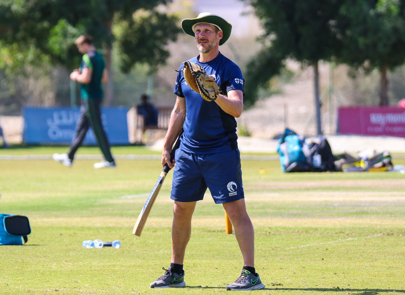 Toby Bailey leads Scotland's squad through a fielding drill before the start of play