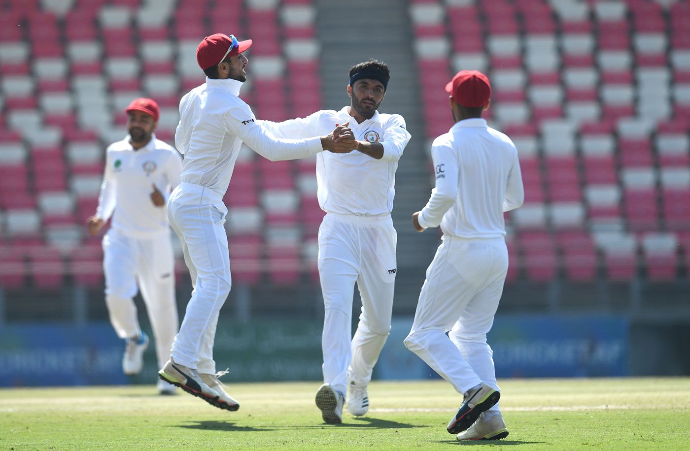 Yamin Ahmadzai celebrates after getting a wicket