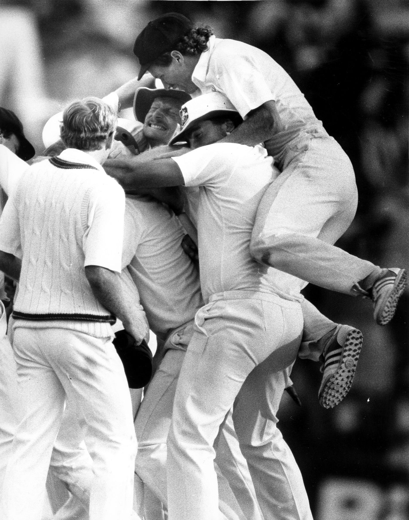 Peter Taylor is swamped by teammates