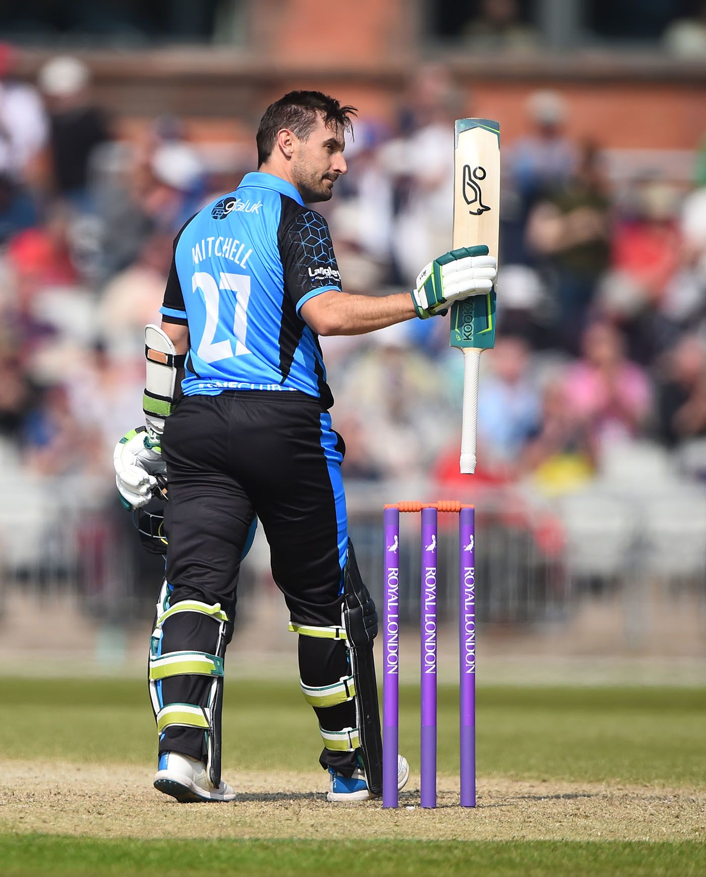 Daryl Mitchell raises his bat