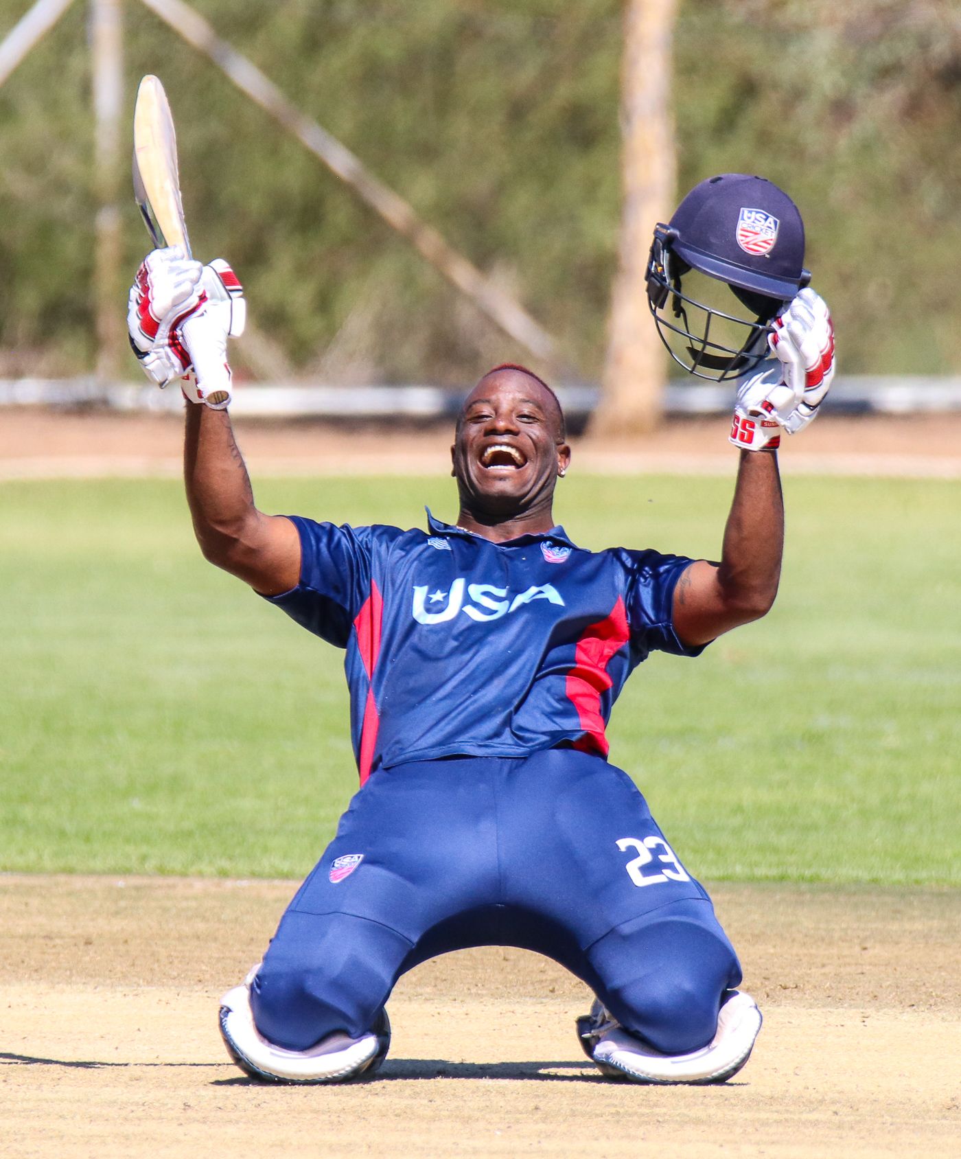 Xavier Marshall drops to his knees in celebration of his first official century for USA