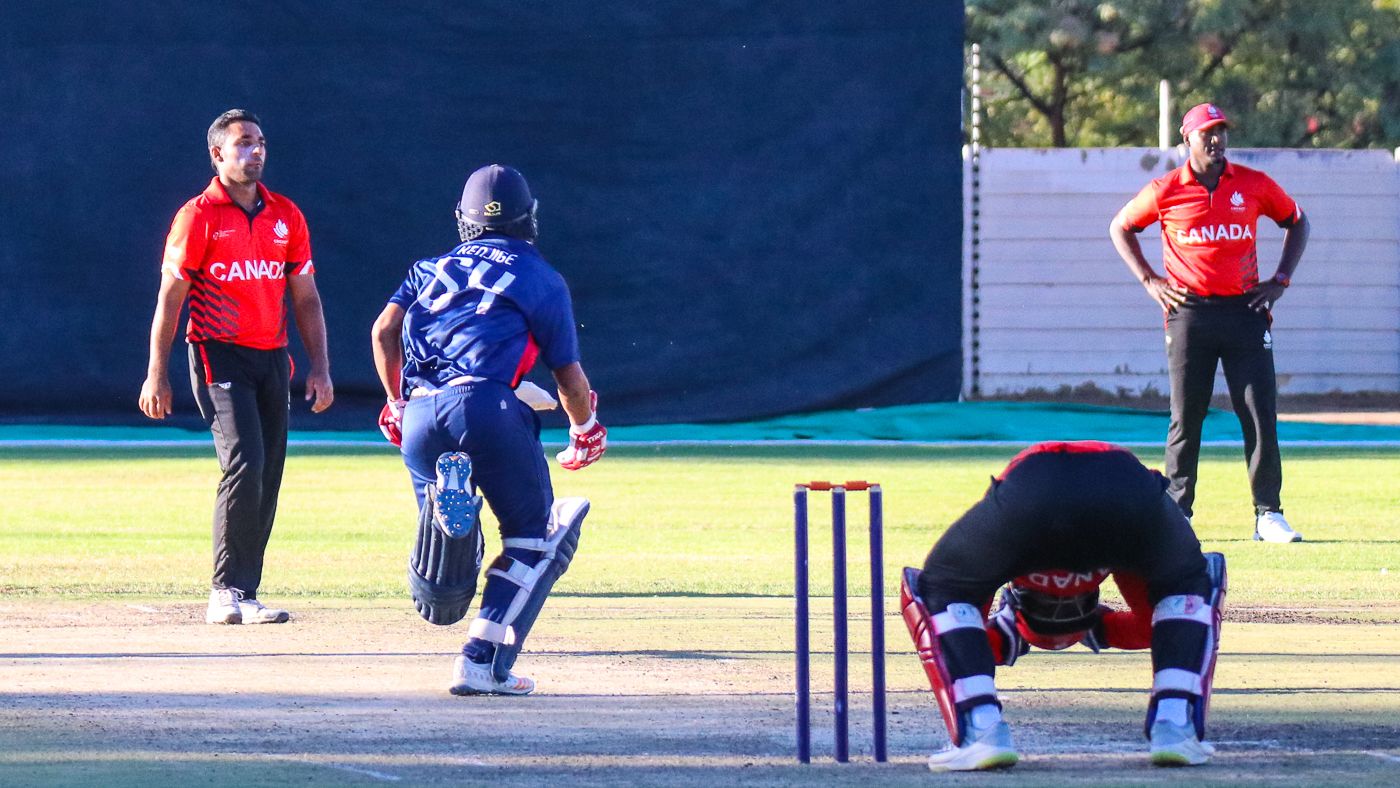 Wicketkeeper Srimantha Wijeyeratne looks down in agony as tailender Nosthush Kenjige's final-over boundary dropped Canada below PNG on net run rate tiebreaker