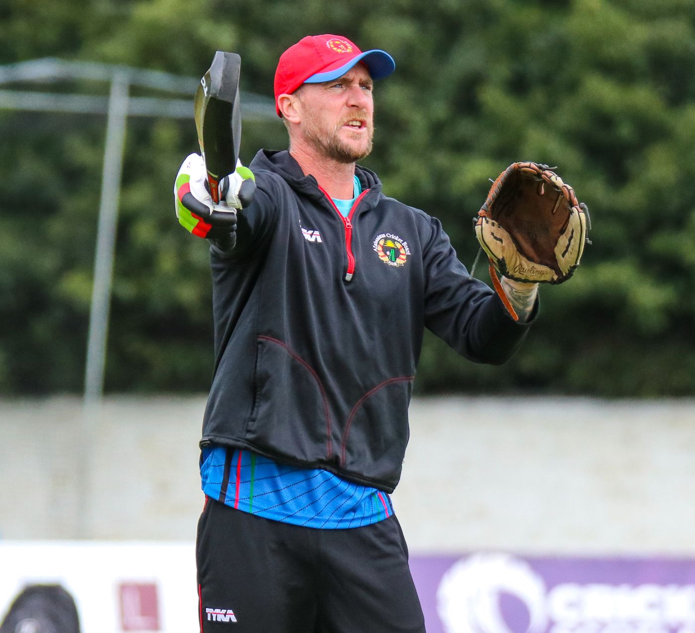 Fielding coach John Mooney directs the squad during an Afghanistan training session